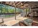 Covered patio area offers shaded seating, overlooking the fenced-in pool and lush backyard, perfect for outdoor entertaining at 5247 Hayden Farms Dr, Powder Springs, GA 30127