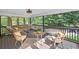 Relax on this covered porch with patio furniture, outdoor rug, and a hammock overlooking the wooded backyard at 5247 Hayden Farms Dr, Powder Springs, GA 30127