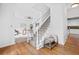 Bright white staircase with gray carpet, wood floors and view into the formal living room at 5247 Hayden Farms Dr, Powder Springs, GA 30127
