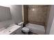 Bathroom featuring a tiled shower, a soaking tub, and a single sink vanity offering practicality and style at 1182 Demere Dr, Stone Mountain, GA 30083
