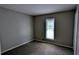 A carpeted bedroom with a window brings in natural light, creating a cozy and inviting atmosphere at 1182 Demere Dr, Stone Mountain, GA 30083