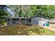 Charming single-story home with gray siding, brown shutters, and a well-maintained front yard at 1182 Demere Dr, Stone Mountain, GA 30083
