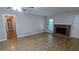 Inviting living area featuring a traditional brick fireplace, wood-look floors, and neutral paint at 1182 Demere Dr, Stone Mountain, GA 30083