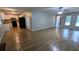 Open-concept living space with kitchen view, wood-look floors, and abundant natural light at 1182 Demere Dr, Stone Mountain, GA 30083