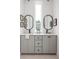 Bright bathroom featuring a double vanity with sleek countertops and stylish, rounded mirrors at 1230 Mado Loop, Chattahoochee Hills, GA 30268