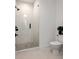 Modern bathroom with walk-in shower featuring white tile and sleek glass door at 1230 Mado Loop, Chattahoochee Hills, GA 30268