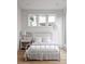 Bright bedroom with a metal frame bed and natural light from the three large windows at 1230 Mado Loop, Chattahoochee Hills, GA 30268