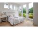 Inviting bedroom with a metal frame bed, complemented by views of the picturesque backyard at 1230 Mado Loop, Chattahoochee Hills, GA 30268