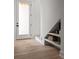 A clean and modern entryway features light wood floors and a built in shelving unit at 1230 Mado Loop, Chattahoochee Hills, GA 30268
