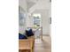 Bright hallway with natural light and a wicker bench, with views of the neighborhood from the window at 1230 Mado Loop, Chattahoochee Hills, GA 30268