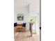 Bright hallway with natural light and a wicker bench to relax and enjoy the views from the window at 1230 Mado Loop, Chattahoochee Hills, GA 30268