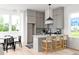 A stylish kitchen features gray cabinets, a center island and a breakfast bar at 1230 Mado Loop, Chattahoochee Hills, GA 30268