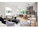 Bright open living space features a modern kitchen, light wood floors and lots of natural light at 1230 Mado Loop, Chattahoochee Hills, GA 30268