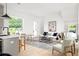 Bright open living space features a modern kitchen, light wood floors and lots of natural light at 1230 Mado Loop, Chattahoochee Hills, GA 30268