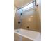 Bright bathroom featuring a shower/tub combo with skylight and tile surround at 341 Little John Nw Dr, Lilburn, GA 30047