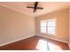 Bright bedroom featuring hardwood floors, ceiling fan, and natural light at 341 Little John Nw Dr, Lilburn, GA 30047
