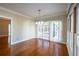 Elegant dining area featuring hardwood floors, modern lighting, and access to the bright sunroom at 341 Little John Nw Dr, Lilburn, GA 30047