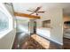 Bright living room with wooden floors, beam, large windows, and an open view into the kitchen at 341 Little John Nw Dr, Lilburn, GA 30047