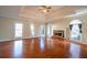 Bright living room featuring hardwood floors, a fireplace, and large windows at 341 Little John Nw Dr, Lilburn, GA 30047