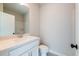 A clean bathroom boasts a white vanity, toilet, and modern patterned tile floor at 4818 Floydwood Ln, Mableton, GA 30126