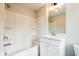 Bright bathroom showcasing a tub and shower combination with white vanity at 4818 Floydwood Ln, Mableton, GA 30126