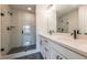 Bathroom featuring a glass-enclosed shower with black accents, a white vanity, and hexagonal floor tiles at 4818 Floydwood Ln, Mableton, GA 30126