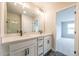 Bathroom with double sinks, quartz countertop, black fixtures, and tiled floors, leading into a bedroom at 4818 Floydwood Ln, Mableton, GA 30126
