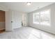 Empty bedroom with an open doorway to an on-suite bathroom and large windows at 4818 Floydwood Ln, Mableton, GA 30126