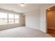 Spacious bedroom with carpet, offering natural light through a window and doorway to another room at 4818 Floydwood Ln, Mableton, GA 30126