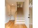 Bright entryway featuring hardwood floors, stairs, and white doors create an inviting foyer at 4818 Floydwood Ln, Mableton, GA 30126