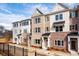 View of modern brick townhomes featuring a landscaped front yard and black wrought iron fence at 4818 Floydwood Ln, Mableton, GA 30126