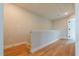 Bright hallway features sleek hardwood floors, crisp white trim, and leads to a closed white door at 4818 Floydwood Ln, Mableton, GA 30126