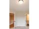 Hallway with two doorways leading to different rooms, neutral walls, and carpet and wood floors at 4818 Floydwood Ln, Mableton, GA 30126
