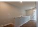 Upstairs hallway featuring hardwood floors, white trim, and door leading to another part of the home at 4818 Floydwood Ln, Mableton, GA 30126