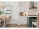 Bright kitchen with white cabinets, a stylish island, and a dining area nearby at 4818 Floydwood Ln, Mableton, GA 30126