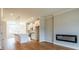 Open-concept living area with wood floors, modern fireplace, and a kitchen with white cabinetry at 4818 Floydwood Ln, Mableton, GA 30126