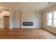 Open living room with hardwood floors, modern fireplace, and large windows that enhance the appeal at 4818 Floydwood Ln, Mableton, GA 30126