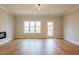 Spacious living room with hardwood floors, crown molding, and a door leading to the backyard at 4818 Floydwood Ln, Mableton, GA 30126
