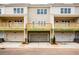 View of townhome with covered parking, balcony, and neutral exterior at 4818 Floydwood Ln, Mableton, GA 30126