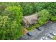 Aerial view of the property showcasing the roof, parking, and lush surrounding trees at 1301 Cumberland Se Ct, Smyrna, GA 30080