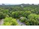 This aerial view shows the property in a wooded setting with parking and city views in the distance at 1301 Cumberland Se Ct, Smyrna, GA 30080
