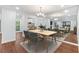 Stylish dining area with hardwood floors, a mirrored wall, and an adjacent modern kitchen at 1301 Cumberland Se Ct, Smyrna, GA 30080