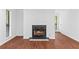 Cozy fireplace in a bright living room with modern wood flooring at 1301 Cumberland Se Ct, Smyrna, GA 30080