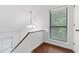 Bright hallway with wood floors, large window, and modern chandelier at 1301 Cumberland Se Ct, Smyrna, GA 30080