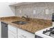Kitchen sink features granite countertops, mosaic backsplash, stainless appliances and white cabinets at 1301 Cumberland Se Ct, Smyrna, GA 30080