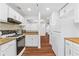 Open kitchen featuring granite counters, wood-look flooring, and stainless steel appliances at 1301 Cumberland Se Ct, Smyrna, GA 30080