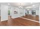 Open-concept living space with wood floors and view into kitchen at 1301 Cumberland Se Ct, Smyrna, GA 30080
