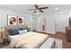This bright main bedroom features fresh white paint, wood floors, ceiling fan and ensuite bath at 1301 Cumberland Se Ct, Smyrna, GA 30080