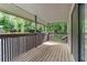 Covered patio with wood floors and railing offers a peaceful outdoor space at 1301 Cumberland Se Ct, Smyrna, GA 30080