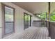 A covered patio with wood floors and railing provides outdoor relaxation space at 1301 Cumberland Se Ct, Smyrna, GA 30080